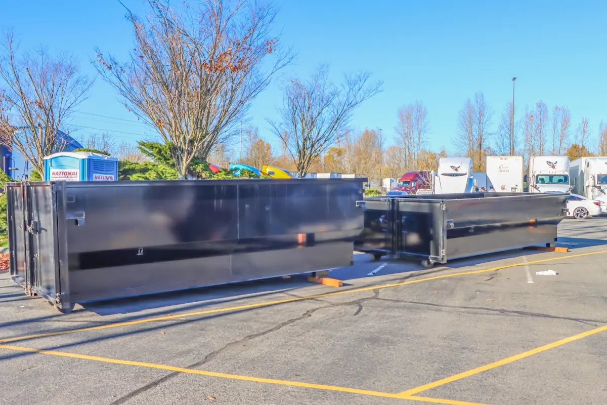 Professional dumpster rental service with roll-off container on residential driveway in Baldwin Park